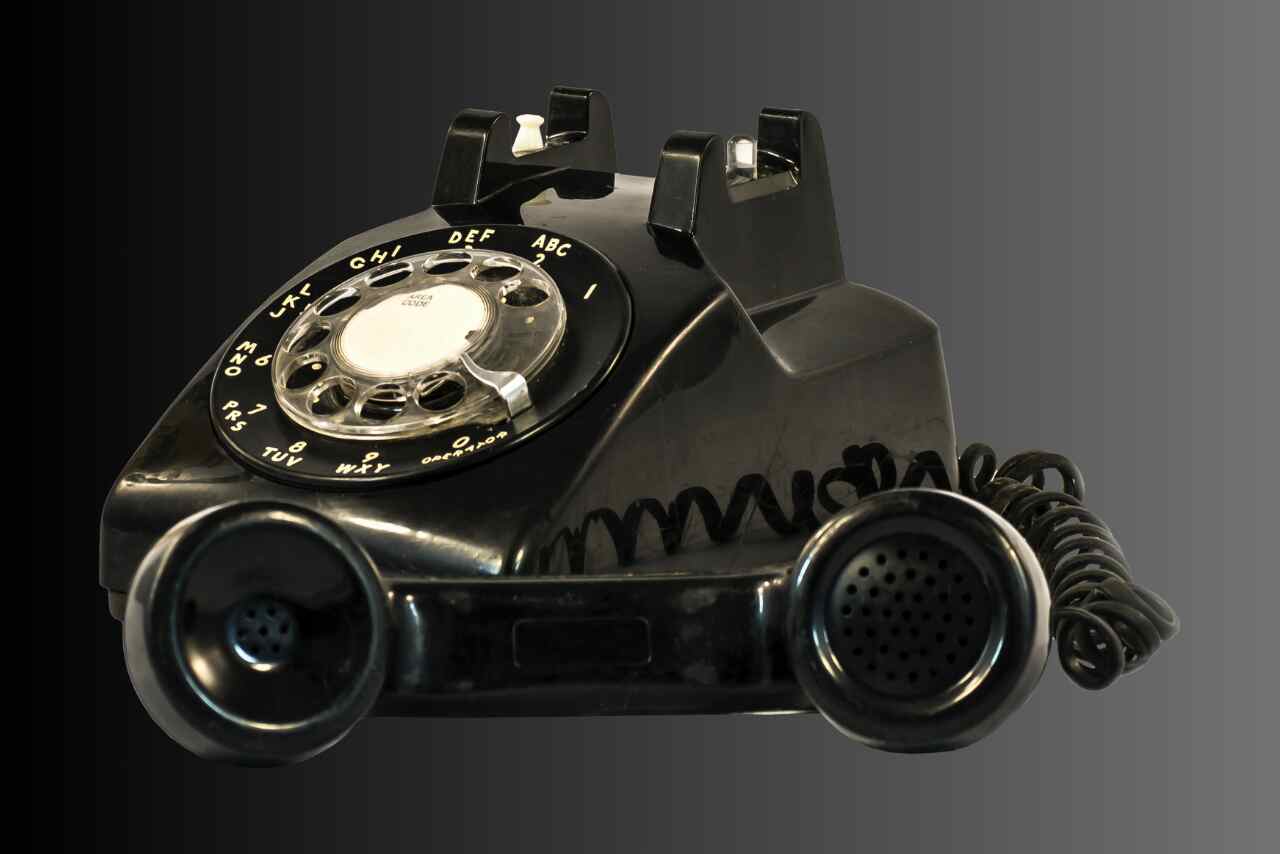 Old rotary phone cutout showcasing vintage communication design.